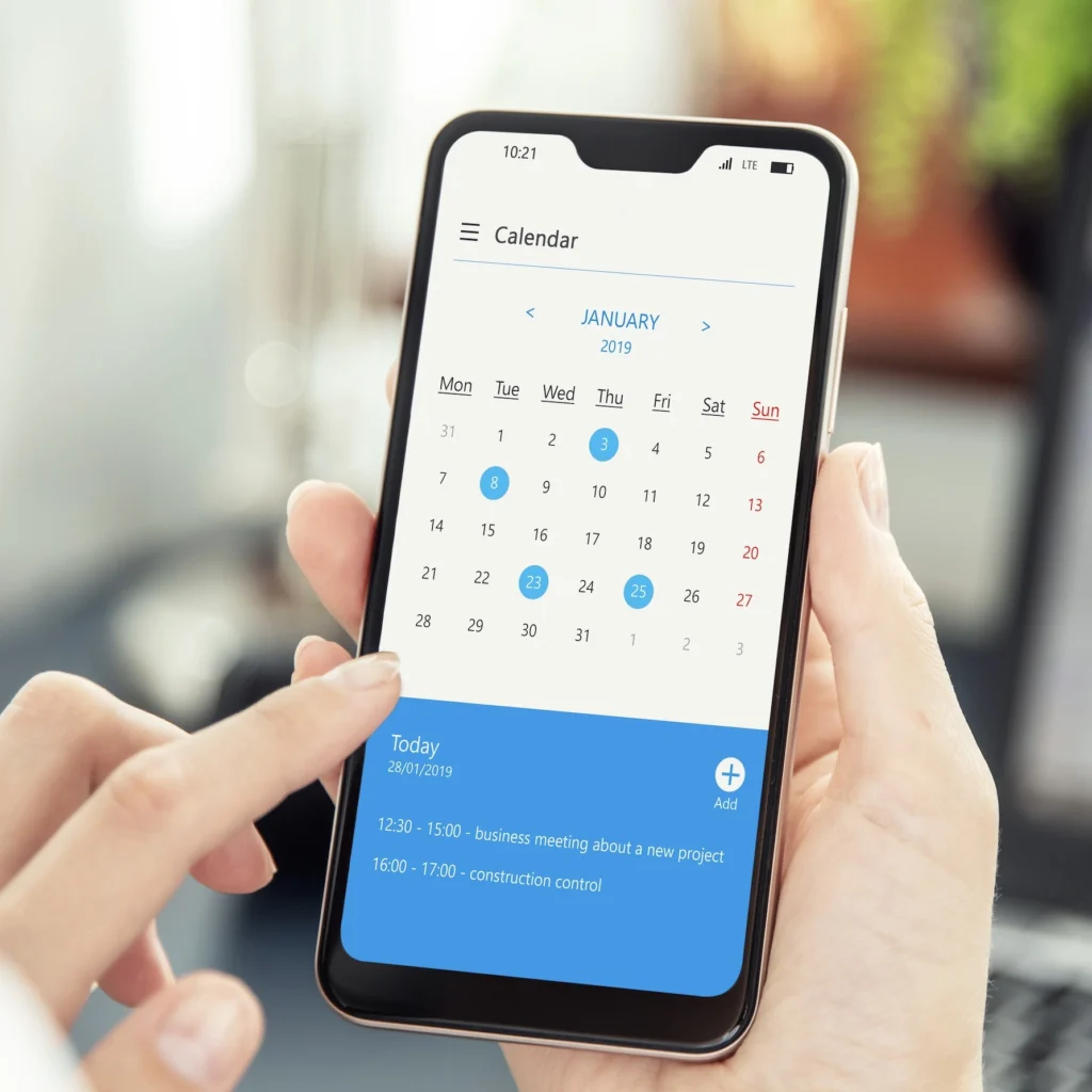 Close-up of someone looking at a smartphone calendar.