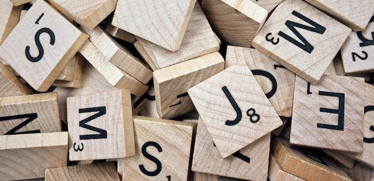 A pile of Scrabble Tiles.